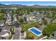 Expansive aerial view showcasing a community pool, lush greenery, and stunning mountain views at 5006 S Nelson St # B, Littleton, CO 80127