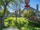 Spacious backyard with lush green grass and a view of the two-story blue home with mature trees at 5006 S Nelson St # B, Littleton, CO 80127