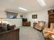 This finished basement features carpet, a couch, and two chairs at 5006 S Nelson St # B, Littleton, CO 80127