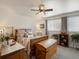 Comfortable bedroom with wooden furniture, ceiling fan, and curtains at 5006 S Nelson St # B, Littleton, CO 80127