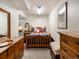 Charming bedroom with wooden furniture, a queen bed with a colorful plaid comforter, and a cozy atmosphere at 5006 S Nelson St # B, Littleton, CO 80127