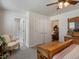 This bedroom includes wood furniture, ceiling fan, and multiple doorways at 5006 S Nelson St # B, Littleton, CO 80127
