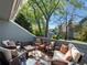 Inviting patio with comfortable seating, surrounded by lush trees and greenery with blue siding at 5006 S Nelson St # B, Littleton, CO 80127