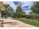 A spacious backyard with a concrete patio, dining table, and lush lawn perfect for outdoor activities at 2692 S Osceola St, Denver, CO 80219