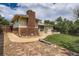 A well-maintained backyard features a brick chimney and patio space perfect for relaxation and entertainment at 2692 S Osceola St, Denver, CO 80219