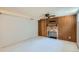 Spacious basement with a brick fireplace and wood paneling at 2692 S Osceola St, Denver, CO 80219
