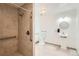 Accessible bathroom with a tiled shower, grab bars, and pedestal sink at 2692 S Osceola St, Denver, CO 80219