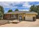 Charming brick ranch-style home featuring a well-maintained front yard and attached one car garage at 2692 S Osceola St, Denver, CO 80219