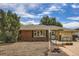 Charming brick single-story home featuring a well-maintained lawn, covered entryway, and attached garage at 2692 S Osceola St, Denver, CO 80219