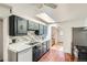 Bright kitchen with a skylight, sleek countertops, and stylish black cabinets at 2692 S Osceola St, Denver, CO 80219
