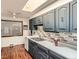 Well-lit kitchen features stylish blue cabinets, a double sink, and plenty of counter space at 2692 S Osceola St, Denver, CO 80219