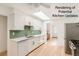 Bright kitchen features white cabinetry, stainless steel appliances, and a skylight at 2692 S Osceola St, Denver, CO 80219