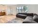 Bright living room featuring hardwood floors, a bay window, and a comfortable, modern sofa at 2692 S Osceola St, Denver, CO 80219