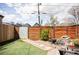Landscaped backyard featuring a wooden fence, stone pathway, green grass, and a rock water feature at 3733 N Franklin St, Denver, CO 80205