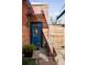Charming brick home featuring a blue front door, classic details, and a welcoming entrance at 3733 N Franklin St, Denver, CO 80205