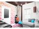 Eclectic living room with flamingo wallpaper, exposed brick, a cozy couch, and bright, bold decor at 3733 N Franklin St, Denver, CO 80205
