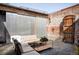 Outdoor patio area with comfortable seating, industrial accents, and a charming brick wall at 3733 N Franklin St, Denver, CO 80205