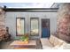 Cozy backyard patio with a comfortable seating area, exposed brick and corrugated steel at 3733 N Franklin St, Denver, CO 80205