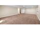 Open basement space with neutral paint, carpet, and ample room for storage, recreation, or hobbies at 1694 Jennifer St, Brighton, CO 80601