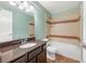 Well-lit bathroom with a granite vanity, and a shower-tub combo with tiled walls and ample space at 1694 Jennifer St, Brighton, CO 80601