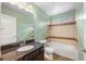 Bathroom with granite countertops, single sink, shower, and bright vanity lights at 1694 Jennifer St, Brighton, CO 80601
