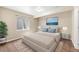 Serene bedroom with a plush bed, neutral tones, and a window providing natural light at 1694 Jennifer St, Brighton, CO 80601