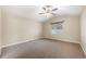 Bedroom features neutral walls and carpet, and a window for natural light at 1694 Jennifer St, Brighton, CO 80601