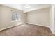 Bright bedroom with neutral tones and large window, offering a blank canvas for personalization at 1694 Jennifer St, Brighton, CO 80601