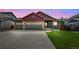 Charming two-story home featuring a three-car garage and well-maintained front yard at 1694 Jennifer St, Brighton, CO 80601