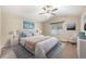 Bright main bedroom boasts a ceiling fan, neutral walls, and soothing decor at 1694 Jennifer St, Brighton, CO 80601