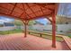 Pergola on wooden deck with overhead lighting in the backyard, perfect for outdoor gatherings at 1694 Jennifer St, Brighton, CO 80601