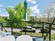 Cozy balcony featuring outdoor seating with a view of green trees, cars, and a blue sky at 4181 W 118Th Pl, Westminster, CO 80031