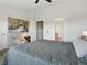 Bedroom with neutral colors with art, a comfortable chair, and adjacent door to a bathroom at 4181 W 118Th Pl, Westminster, CO 80031