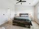 Bedroom featuring a large bed with stylish headboard and neutral decor, plus adjacent doorway at 4181 W 118Th Pl, Westminster, CO 80031