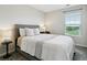 Cozy bedroom featuring a bed with a gray upholstered headboard and a window with natural light at 4181 W 118Th Pl, Westminster, CO 80031