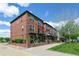 Beautiful brick townhomes featuring balconies, black railings, and lush green landscaping at 4181 W 118Th Pl, Westminster, CO 80031