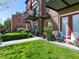 Brick townhome exteriors with manicured lawns, landscaped beds, and outdoor seating areas at 4181 W 118Th Pl, Westminster, CO 80031