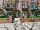 Brick townhome with wrought iron balconies, well-manicured front yard, and walkway at 4181 W 118Th Pl, Westminster, CO 80031