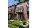 Brick townhome with balconies, an inviting lawn, stone accents, and outdoor seating at 4181 W 118Th Pl, Westminster, CO 80031