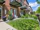 Brick townhomes featuring a well-maintained lawn, landscaping, and patio seating at 4181 W 118Th Pl, Westminster, CO 80031