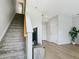 Carpeted stairs lead up from a living area with wood flooring and a flatscreen television at 4181 W 118Th Pl, Westminster, CO 80031
