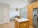 Kitchen island featuring quartz countertops, stainless appliances, and bar stool seating at 4181 W 118Th Pl, Westminster, CO 80031