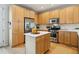 Kitchen island with quartz countertops and stainless steel appliances at 4181 W 118Th Pl, Westminster, CO 80031
