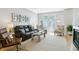 Bright living room with wood floors, stylish furniture, and double doors to balcony at 4181 W 118Th Pl, Westminster, CO 80031