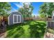 Storage shed located in backyard with privacy fence and mature trees at 19523 E Buchanan Pl, Aurora, CO 80011