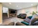 Basement Gathering room with a media center and comfortable seating and natural light at 19523 E Buchanan Pl, Aurora, CO 80011