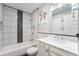 Modern bathroom featuring a tiled shower-tub combo and a stylish vanity with marble countertop at 19523 E Buchanan Pl, Aurora, CO 80011