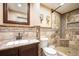 Bathroom featuring stylish shower with unique tile work, elegant vanity, and decorative accents at 19523 E Buchanan Pl, Aurora, CO 80011