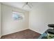 Clean, unfurnished bedroom with neutral carpet, a ceiling fan, and a bright window at 19523 E Buchanan Pl, Aurora, CO 80011