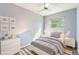 Neutral bedroom with light blue walls, large window, ceiling fan and modern furniture at 19523 E Buchanan Pl, Aurora, CO 80011